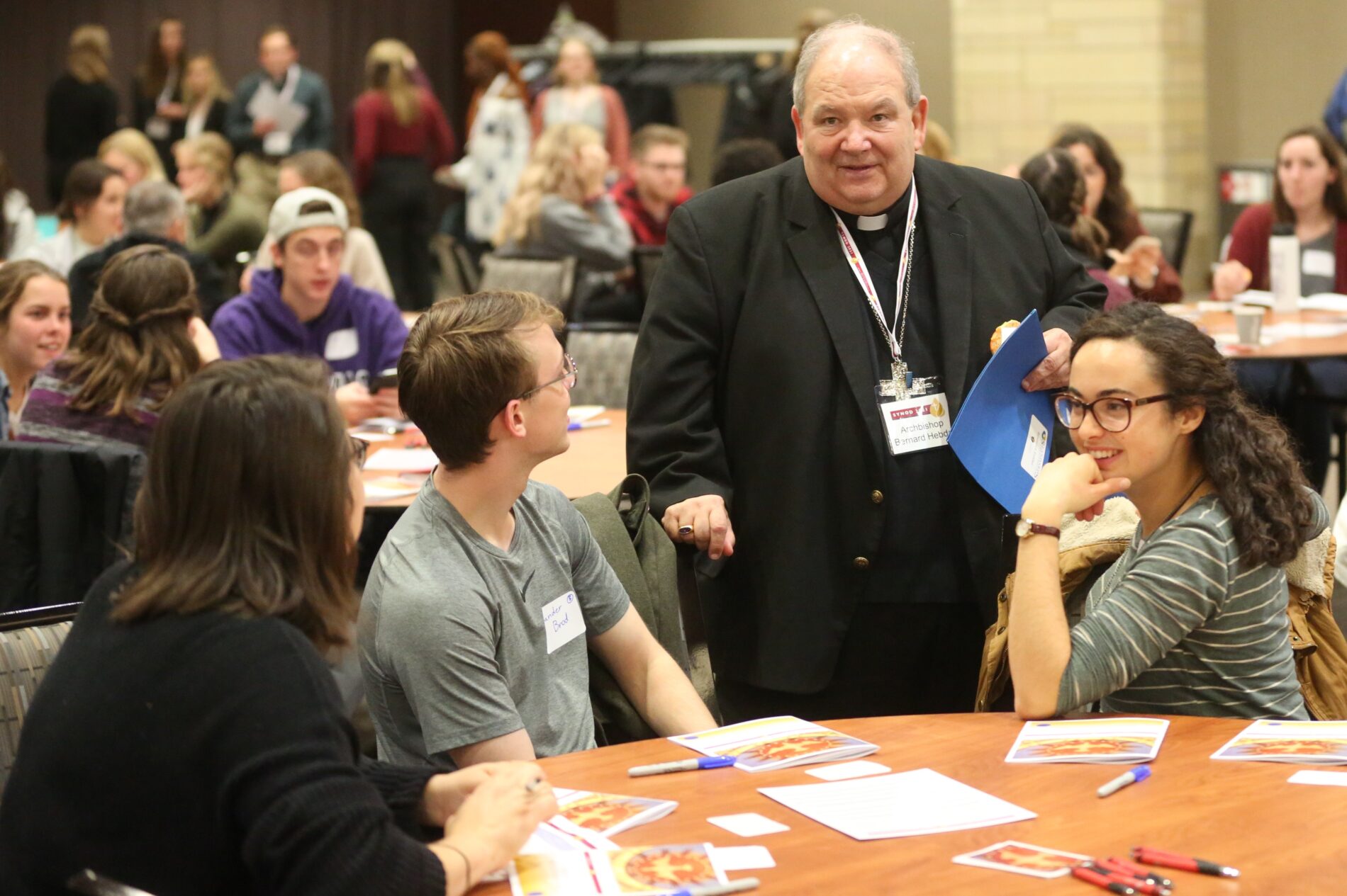 Archbishop speaks with young adults gathered for a Prayer and Listening Event.